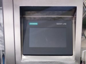 Close-up of control panel and PLC touchscreen